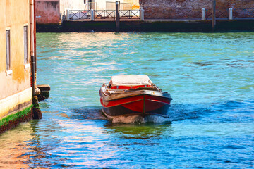 Fototapeta na wymiar Charming scene in Venice Italy, where a boat glides along the water canal