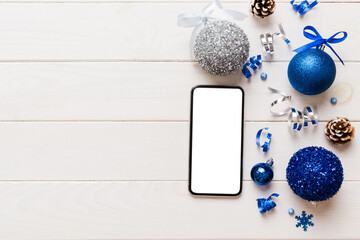 Digital phone mock up with rustic Christmas decorations for app presentation top view with empty space for you design. Christmas online shopping concept. Tablet with copy space on colored background