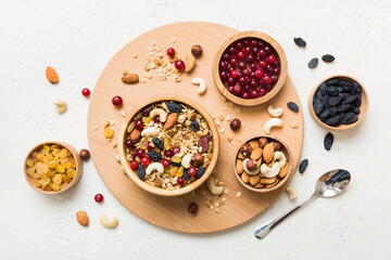 Cooking a wholesome breakfast. Granola with Various dried fruits and nuts in a bowl. The concept of a healthy dessert. Flat lay, top view with copy space