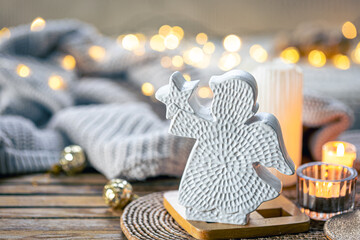 Christmas background with angel figurine and bokeh lights.
