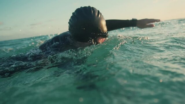 Triathlete swimming, preparing for an Ironman triathlon competition