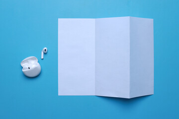 Blank flyer with air pods on blue background
