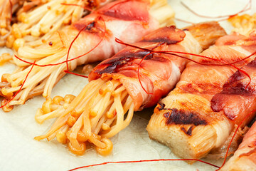 Enoki mushrooms rolls, close up.