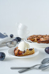 Homemade plum pie. Plum cake on a white background.  Dessert with ice cream.