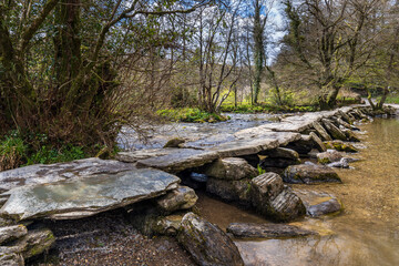 The Tarr Steps, a medieval clapper bridge over the River Barle in the Exmoor National Park,...