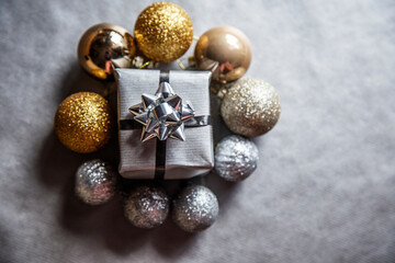 Christmas and New Year background with silver gift box and gold and silver Christmas balls around....