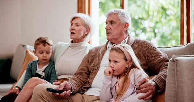 Watching tv or streaming with grandparents and children on a sofa in the living room of a home during a visit. Relax, subscription or entertainment with senior people looking after their grandkids