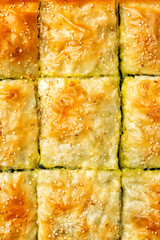 Food background, top view of pie made with phyllo or filo pastry with sesam seeds.