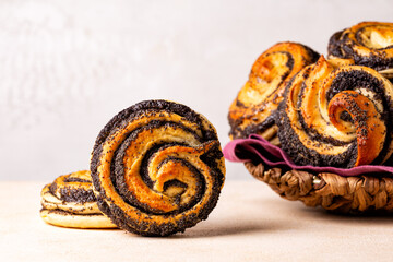 Close up of baked homemade sweet poppy seeds buns, eastern European classic sweet yeast dough, swirl shape. Selective focus.