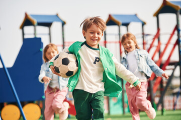 Cheerful kids are having fun on the playground