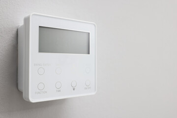 One thermostat on white wall, closeup and space for text. Smart home system