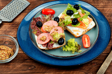 Open sandwiches with fish and sausages.