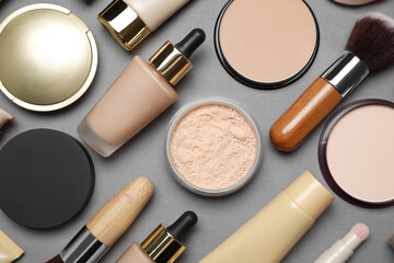 Face powders and other makeup products on grey background, flat lay - obrazy, fototapety, plakaty