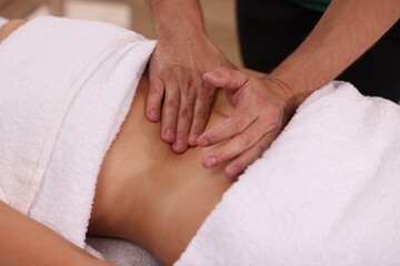 Fototapeta na wymiar Woman receiving professional belly massage indoors, closeup