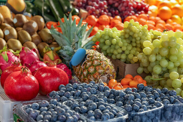 Many different fresh fruits on counter at wholesale market