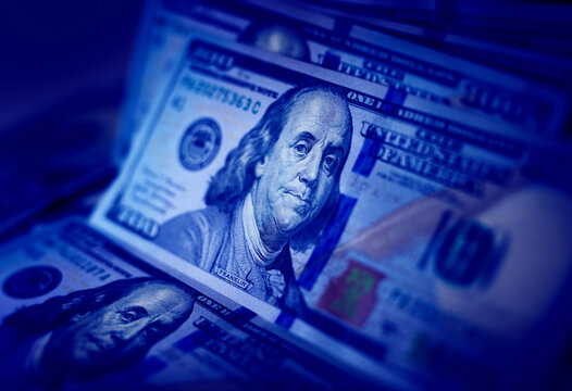American dollars texture, concept of bank, taxes, income, successful business. 100 dollar bills on with blue light.