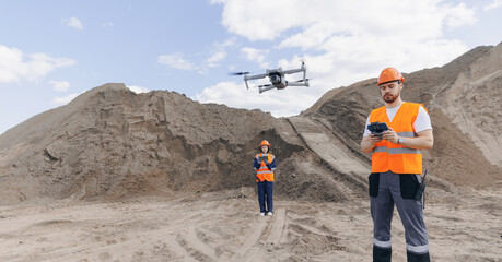 Team specialists operator inspecting construction site, industrial open pit mine sand quarry. Drone industry inspection from pilot engineer