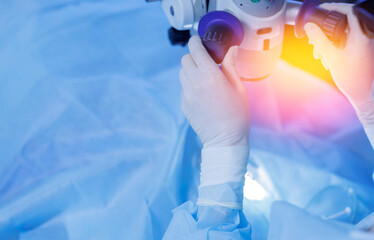 Lasik treatment. Laser vision correction. Doctor examines fundus in microscope, patient under...