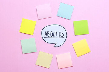 About Us text with blank sticky notes on pink background