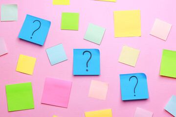 Question marks with colorful blank sticky notes on pink background