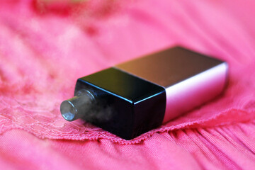 Women's electronic cigarette on a pink dress