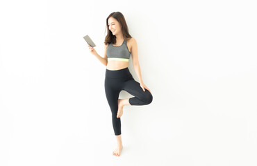 Beautiful Asian Korean sport body slim woman in sportswear standing relax and practicing yoga do...