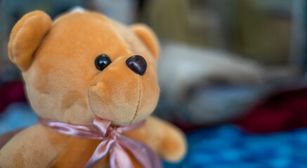 Brown fabric teddy bear, teddy bear on background with checkered pattern