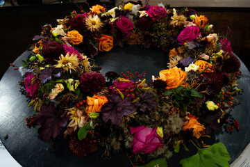 Purple and orange roses arranged in a wreath