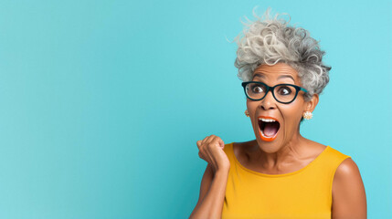 Young african american woman wearing casual clothes and glasses celebrating surprised and amazed for success with arms raised and open eyes. winner concept. - obrazy, fototapety, plakaty