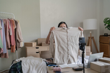 Asian Woman dressmaker working in fashion studio design and shipping an online order with woman sending package&nbsp;online consulting at clothing shop