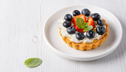 Creamy cheesecake cake with blueberry and strawberries. Copy Space