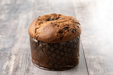 Christmas panettone cake with chocolate chips on wooden table