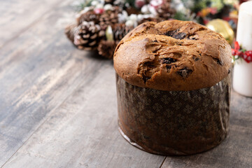 Christmas panettone cake with chocolate chips on wooden table. Copy space
