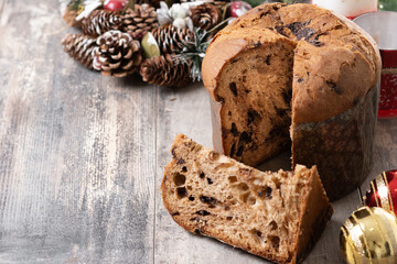 Christmas panettone cake with chocolate chips on wooden table. Copy space
