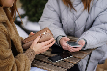 Close-up of girl's hands holding open purse. Billing for online services.