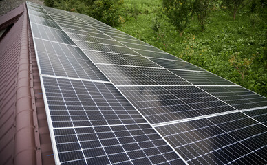 Solar photovoltaic panel system on modern house roof.