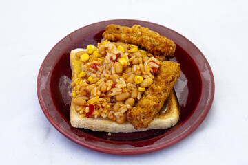 Fish portions with a rice and vegetable mix on a slice of white bread toast