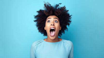 Young african american woman wearing afro hair standing over isolated blue background celebrating mad and excited for success with arms raised and closed eyes screaming excited. winner