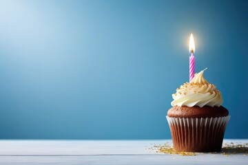 birthday cupcake with candle on blue background