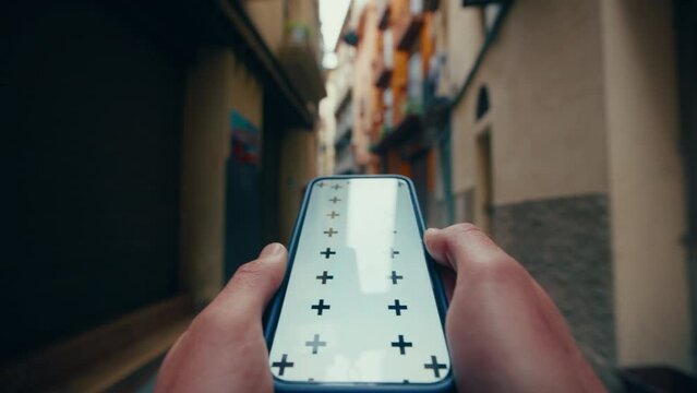 Tourist navigate in city street using smartphone as GPS navigator pov shot