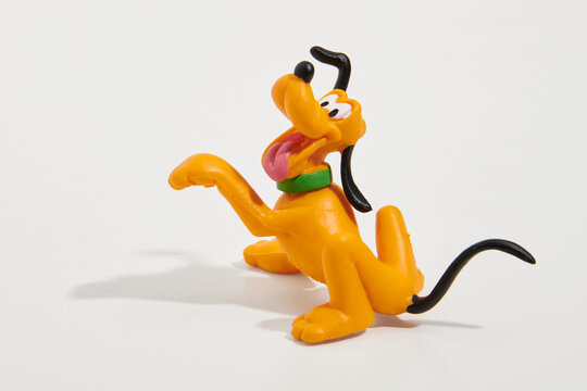 Toy figure of Pluto dog on white background