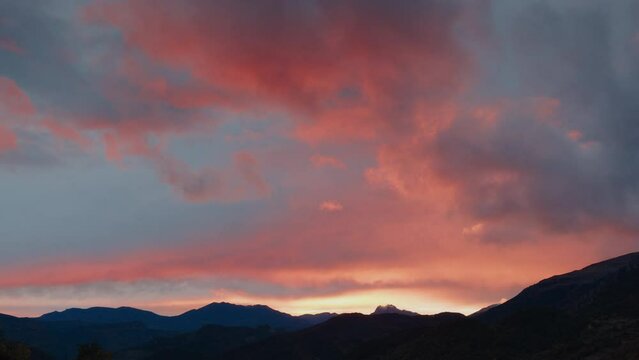 Tilt down overlooking sunset sky and mountain landscape on travel destination
