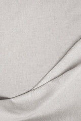 Elegant neutral beige oat color linen draped fabric background with smooth folds, aesthetic minimal...