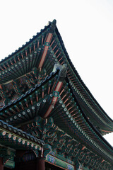 Fototapeta na wymiar The roof of a traditional South Korean house looks down on a white background