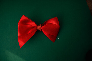 Red bow on a green background. Place for text