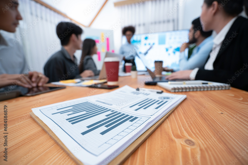 Poster focus financial dashboard paper showing graphs and chart with blurred background of diverse business