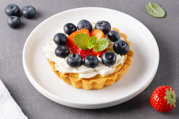 Creamy cheesecake cake with blueberry and strawberries