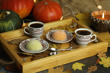 Colorful japanese sweets daifuku or mochi sliced. Sweets close up on the plate with cup of coffee