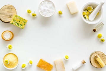 Herbal organic cosmetics products with chamomile flowers, top view