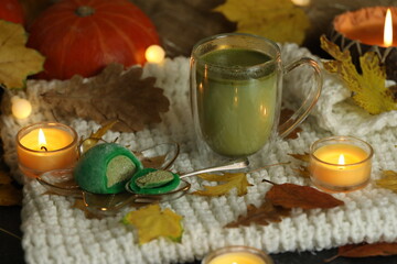 Colorful japanese sweets daifuku or mochi sliced. Sweets close up on the plate with cup of matcha tea